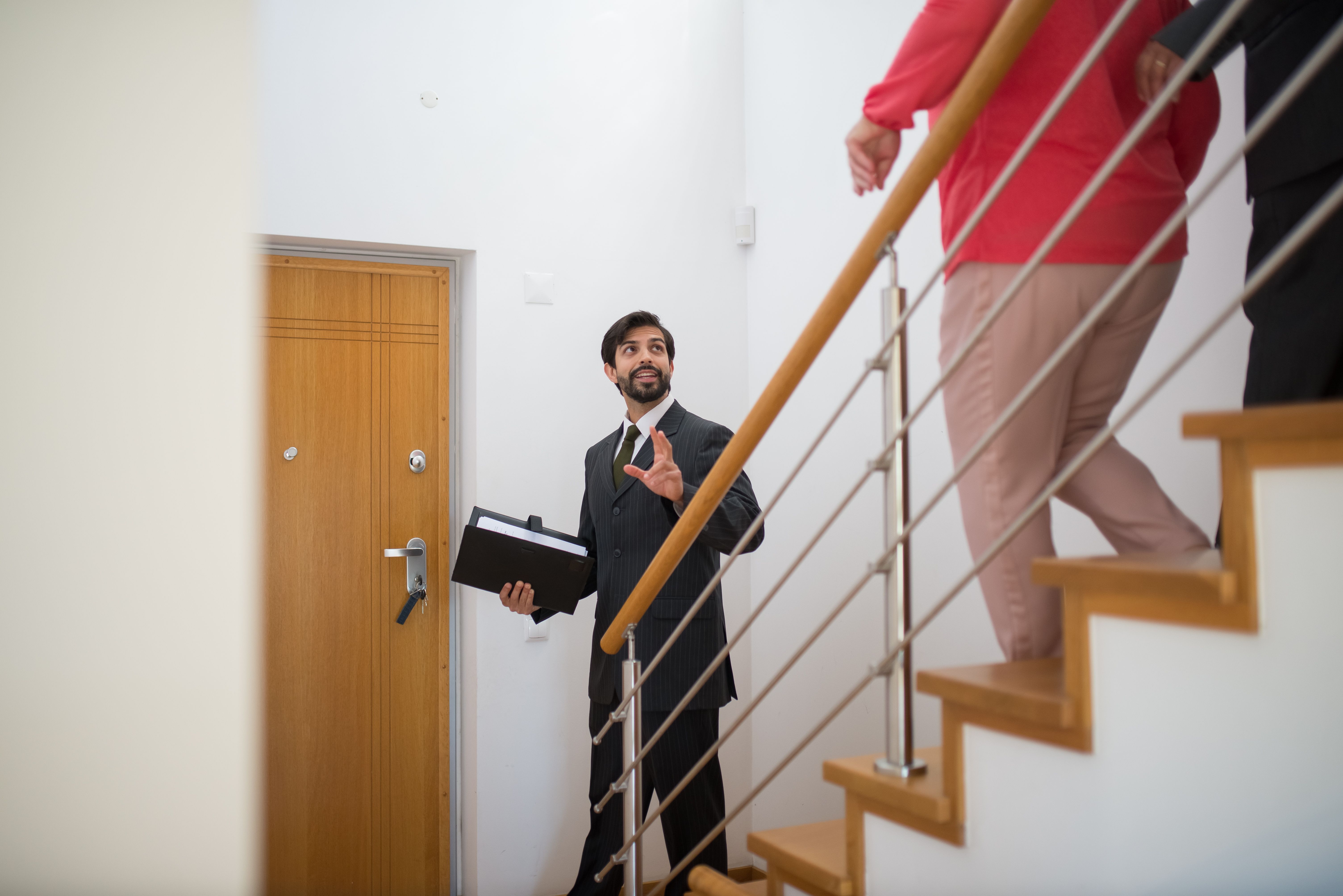 Property Manager giving a consultation to two clients on a stair way